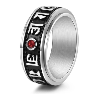 Rotating stainless steel mantra ring with red crystal and embossed Sanskrit symbols