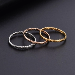 Three-piece stackable twisted rope rings set in 18K gold, silver, and rose gold finish