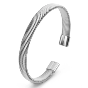 Macro shot of silver C-shaped elastic bracelet with detailed spiral coil texture finish