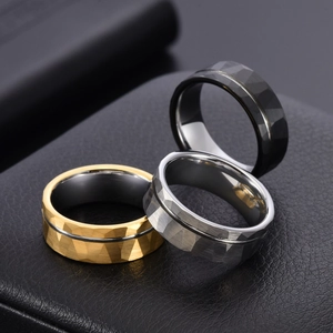 Detail of 8mm tungsten rings with hammered finish in gold, silver, and black colors