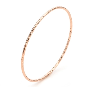 Minimalist 18K rose gold plated titanium steel bangle with textured geometric facets