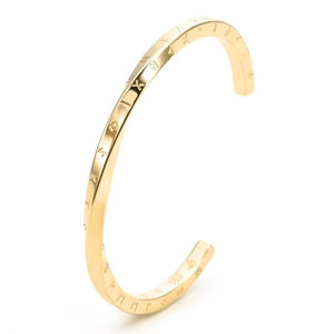 Macro view of gold-plated stainless steel C-shaped cuff with engraved Roman numerals