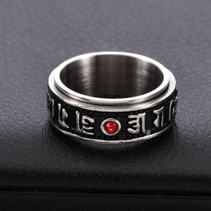 Vintage rotating stainless steel ring with red zircon and engraved Buddhist mantra symbols