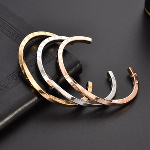 Polished C-shaped Mobius bangle in gold, silver, and rose gold with Viking carvings