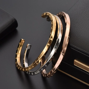 Three Viking Futhark rune cuff bracelets in gold, silver, and rose gold finish