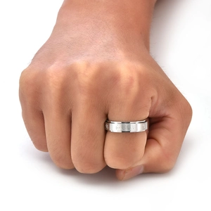 Detailed close-up of brushed stainless steel rotating ring with engraved ancient symbols
