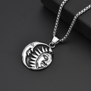 Vintage titanium steel sun and moon pendant necklace on a black jewelry box background