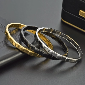 Men's 18K gold plated titanium steel bangles in gold, black, and silver finishes