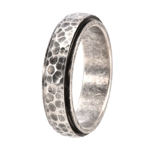 Detailed view of vintage silver spinner ring with hand-hammered texture and rotating band