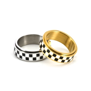 Detailed close-up showing gold and silver titanium steel rings with black and white grid enamel
