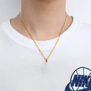 Macro view of gold Allah pendant with oval shape and clear rhinestones on a slim chain