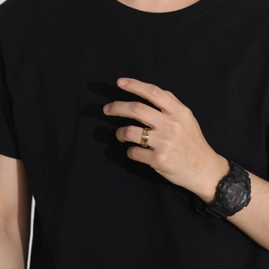 Detail of gold rotating ring for men with engraved vintage sun moon and star celestial motifs