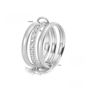 Macro shot of silver titanium steel triple-layer ring with sparkling zircon stones