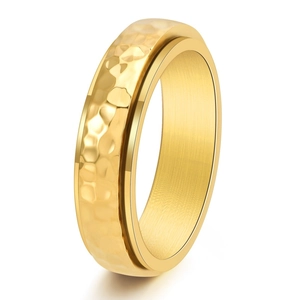 Golden titanium spinner ring for men with handmade hammered texture and polished edges