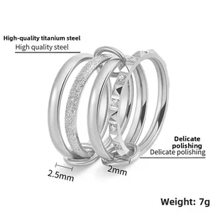 Detail of 18K gold titanium stacked rings with cubic zirconia and polished textures
