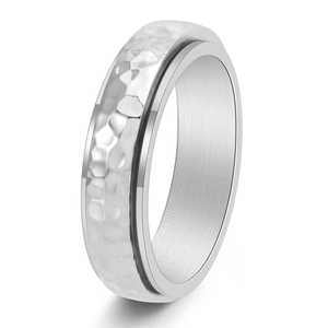 Detailed macro view of silver spinner ring with textured hammered finish and polished edges