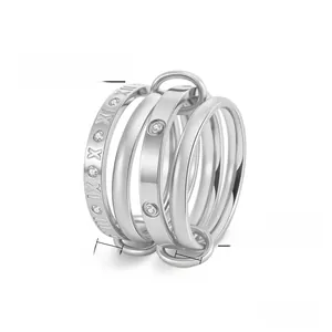 Macro detail of stacked titanium steel rings with Roman numerals and diamond accents