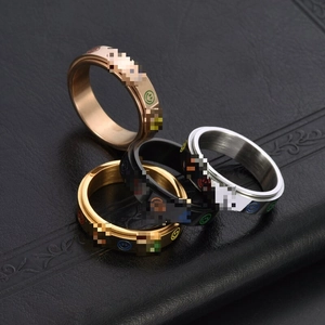 Macro shot of spinning stainless steel rings with colorful smiley face motifs