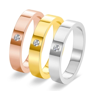 Detailed view of three minimalist 18K gold-plated rings in rose, gold and silver finishes