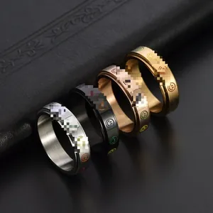 Detail view of four rotating stainless steel rings with colorful smiley face patterns
