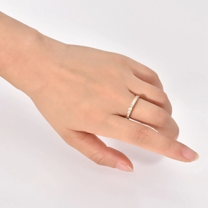 Detail shot of a slim 18K gold titanium ring with a full circle of pavé set zircons