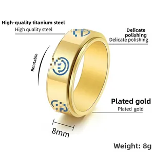 Detail of 8mm gold titanium rotating ring with blue smiley face decompression design