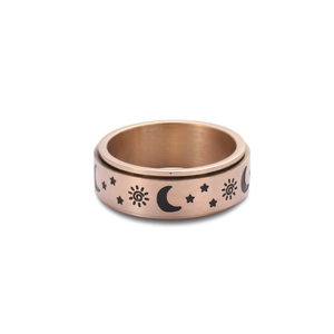 Close-up of rose gold celestial spinning ring with sun and moon engravings