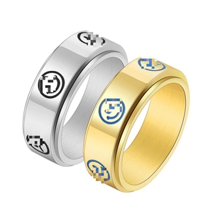 Close-up of rotatable gold and silver titanium steel rings with engraved emoji pattern