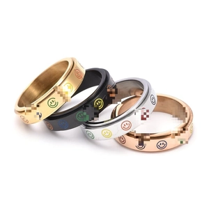 Rotating stainless steel spinner rings set with colorful smiley faces in four finishes