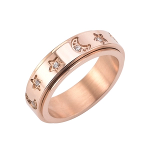 Detailed macro view of rose gold spinner ring with engraved star and moon patterns