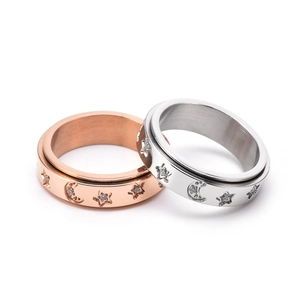 Rotating stainless steel star and moon stress relief ring in rose gold and silver