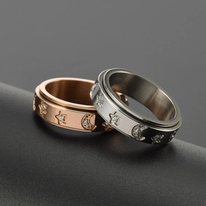 Polished stainless steel spinning ring with rhinestone moon and stars in gold and silver