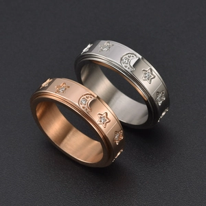 Rotating stainless steel star and moon spinner rings in silver and rose gold finish