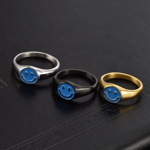 Three-piece smiley face rings in gold silver and black stainless steel with blue enamel