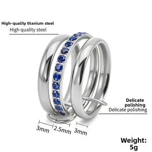 Macro detail of three-layer stackable rings with blue crystal pavé in polished titanium steel