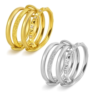 Close-up of interconnected 18K gold and silver rings with pave diamonds and frosted texture