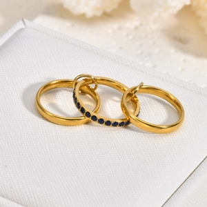 Detailed close-up of 18K gold-plated triple stack rings with a blue sapphire zircon stone