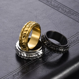 Macro shot of rotatable dragon scale texture rings in gold, silver, and black finish