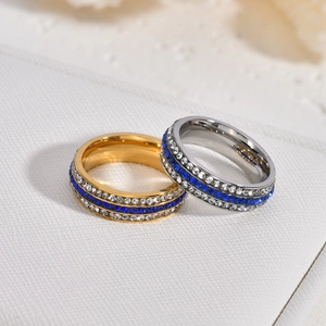 Three-row rhinestone ring set with blue and white zircons in gold and silver finish