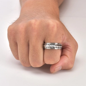 Detailed view of rotating men's dragon scale ring in polished titanium steel texture