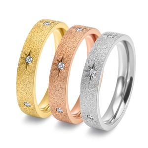 Detailed close-up of three starburst frosted rings in gold, rose gold, and silver finishes