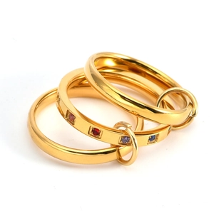 Detail view of 18K gold plated interlocking rings featuring multicolored zircon stones