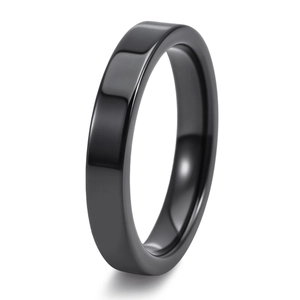Macro detail of a high-polished flat black ceramic band ring with reflective finish