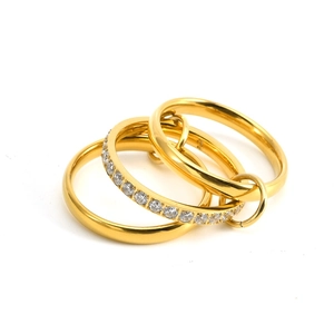 Detail of three interlocking 18K gold rings with sparkling cubic zirconia pavé setting
