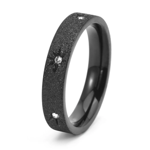 Macro view of black frosted titanium steel ring with three star-set white zircons