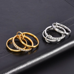 Detail of 18K gold and silver interlinked triple bands with cubic zirconia on black leather