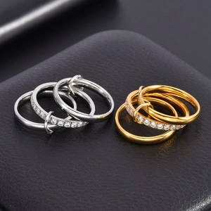 Detail of linked three-layer rings with zircon pavé in gold and silver finish