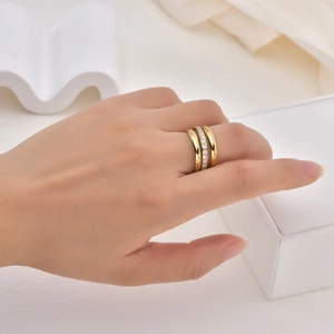 Detailed close-up of a triple-layered 18K gold plated ring with micro-pave diamond setting
