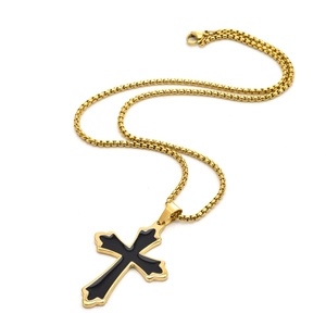 Detail of cross pendant with black enamel inlay and sturdy gold-plated box chain
