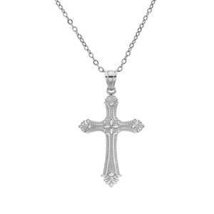 Macro detail of silver cross pendant featuring intricate vintage floral engravings